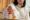 woman picking up a bottle of medication