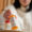 woman picking up a bottle of medication