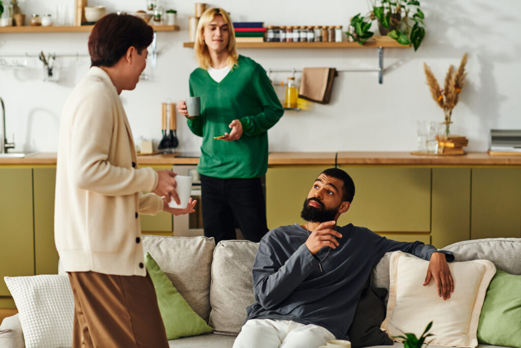 Three handsome young men gather in a modern home, sharing ideas and enjoying each others company.