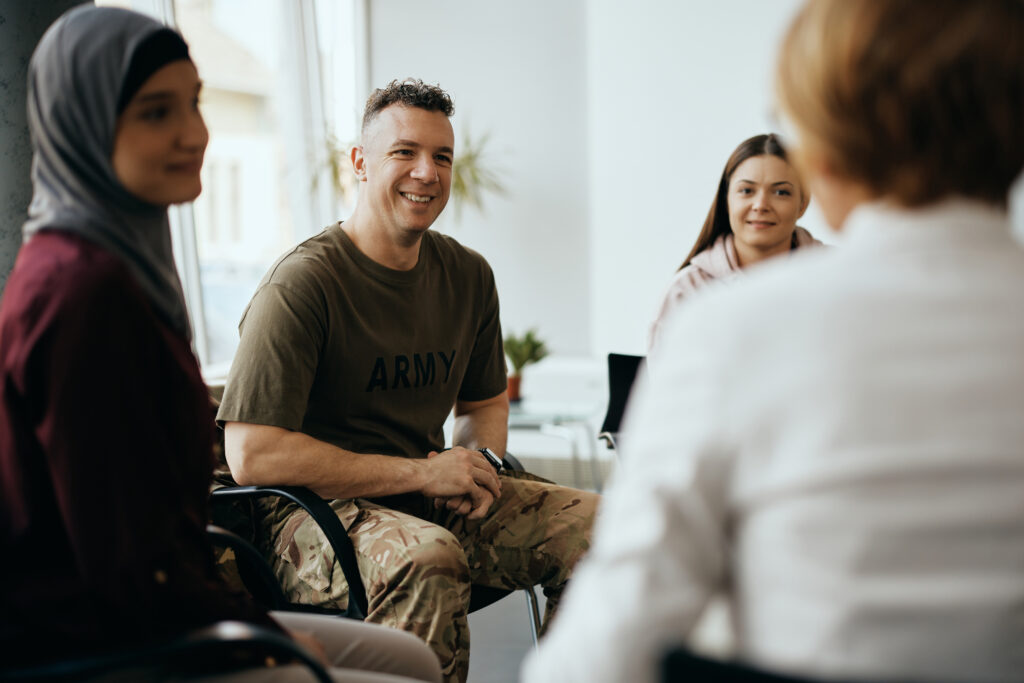 Happy soldier and group of people having group therapy at mental