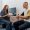 in a modern clinic in a small therapist s office, a young girl doctor with a stethoscope conducts an appointment with a young guy patient diagnosing a problem